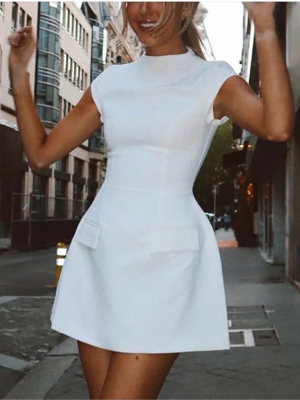Elegant White Cap-Sleeve A-Line Dress by Commense with two faux front pockets.